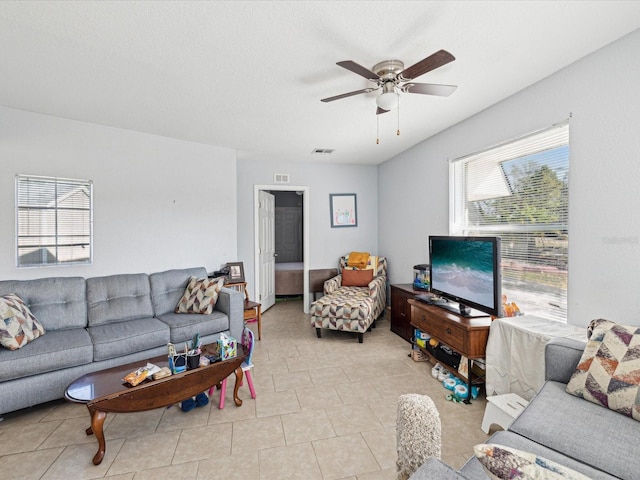 tiled living room featuring ceiling fan and a healthy amount of sunlight