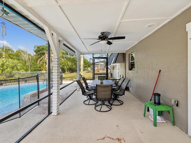 sunroom / solarium featuring ceiling fan