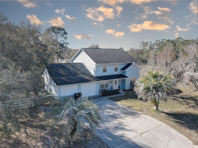 view of front of home featuring a lawn and a garage