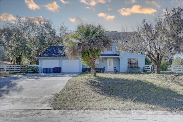 view of front of home featuring a lawn and a garage