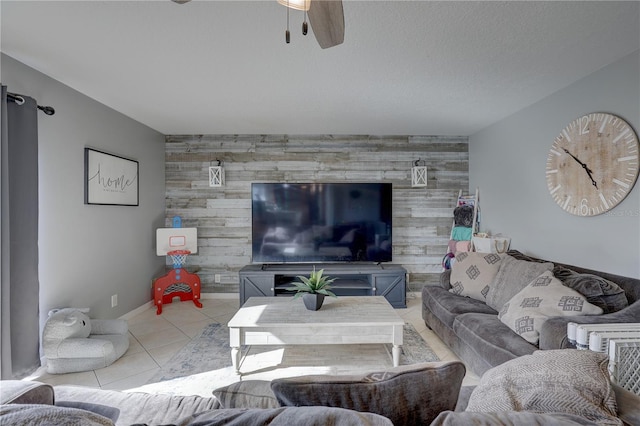 tiled living room with ceiling fan and wood walls