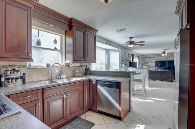 kitchen with ceiling fan, sink, backsplash, light tile patterned flooring, and appliances with stainless steel finishes