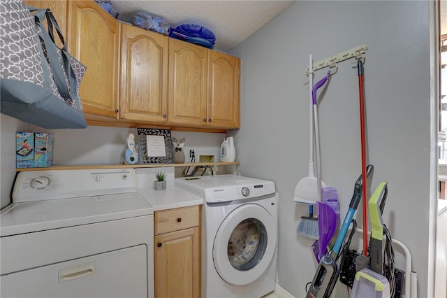 washroom with cabinets, a textured ceiling, and separate washer and dryer