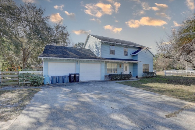 view of front of home with a front lawn and a garage