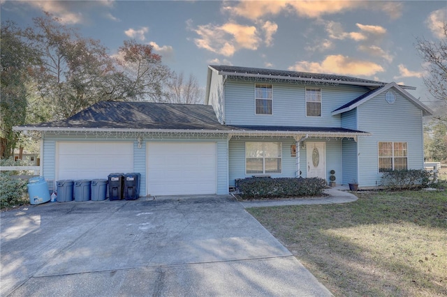 front facade featuring a yard and a garage