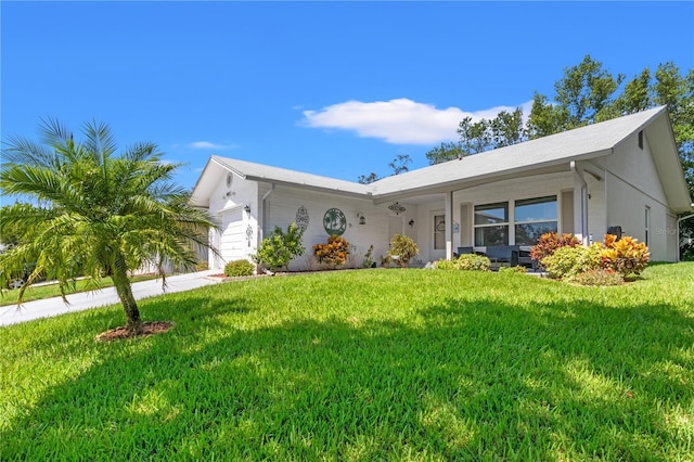 ranch-style home with a garage and a front lawn