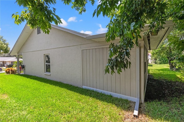 view of side of home with a yard