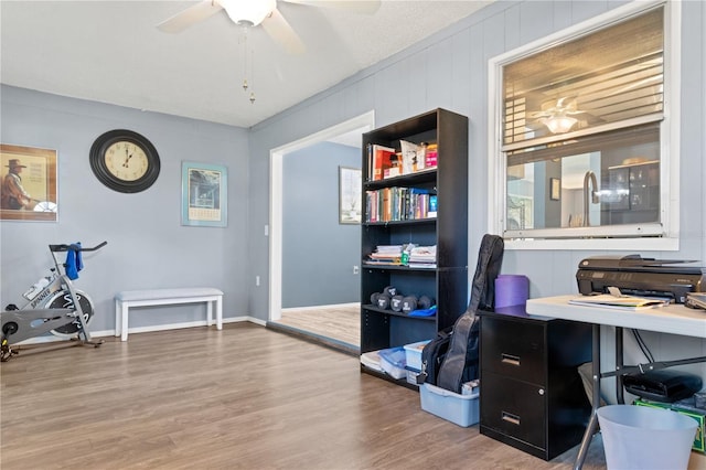 home office featuring hardwood / wood-style floors, a textured ceiling, and ceiling fan