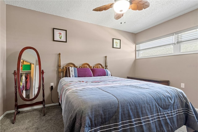 carpeted bedroom featuring a textured ceiling and ceiling fan