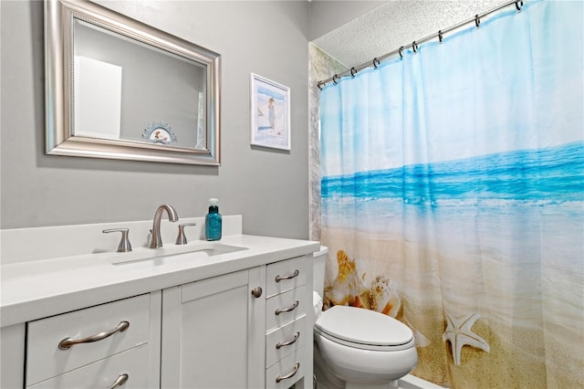 bathroom featuring vanity, curtained shower, and toilet