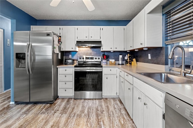 kitchen with appliances with stainless steel finishes, a textured ceiling, ceiling fan, sink, and white cabinets