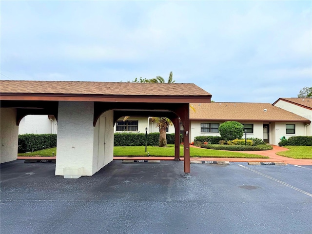 view of vehicle parking featuring a yard