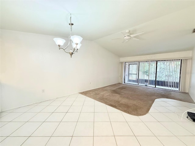 unfurnished room with ceiling fan with notable chandelier, light tile patterned flooring, and lofted ceiling