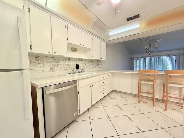 kitchen with pendant lighting, an inviting chandelier, white cabinets, white refrigerator, and stainless steel dishwasher