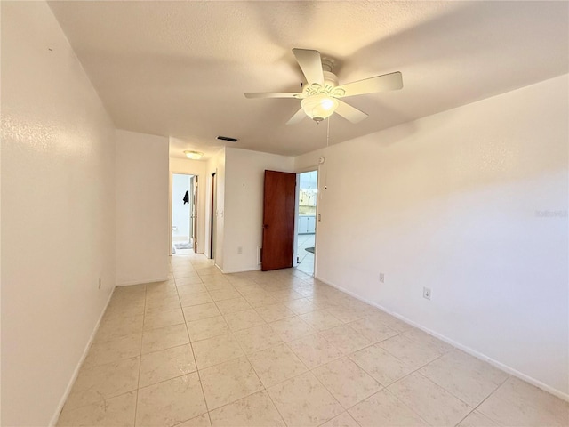 spare room featuring ceiling fan and light tile patterned floors