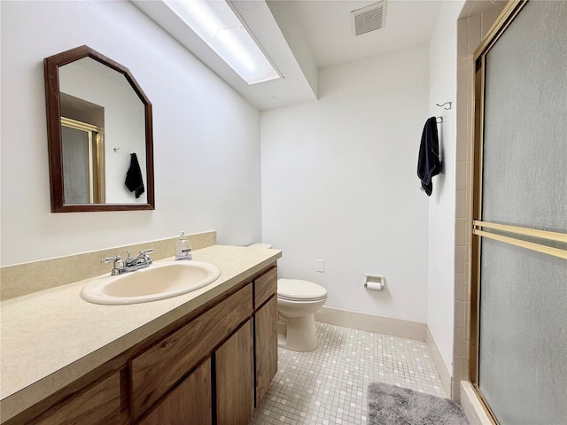 bathroom with tile patterned floors, vanity, toilet, and walk in shower