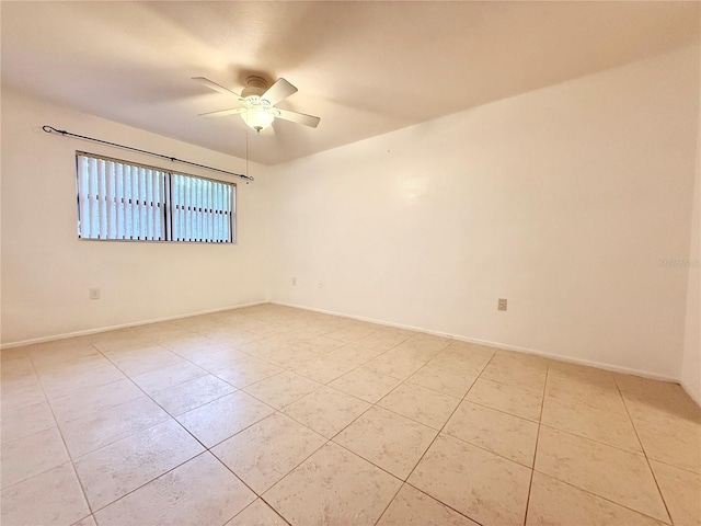 tiled spare room with ceiling fan