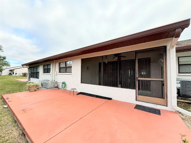 back of property featuring a lawn, a patio, and central AC unit