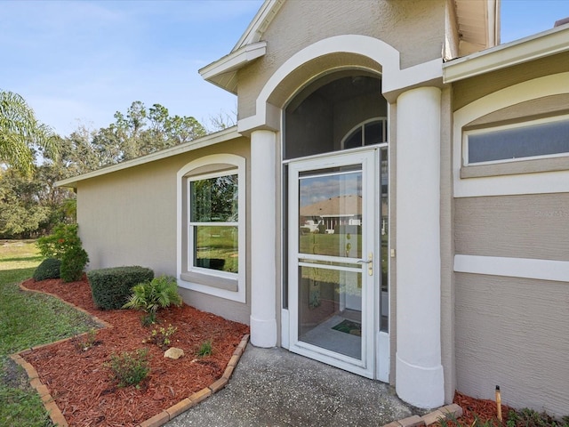 entrance to property with stucco siding