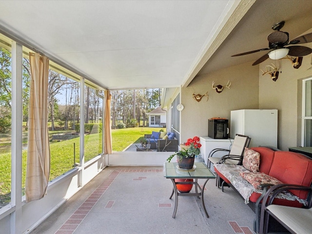 sunroom / solarium featuring ceiling fan