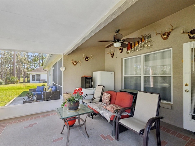 view of patio with a ceiling fan and outdoor lounge area