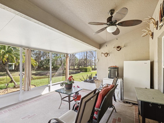 sunroom / solarium with visible vents, a ceiling fan, and beam ceiling