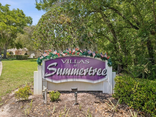 community / neighborhood sign with a lawn