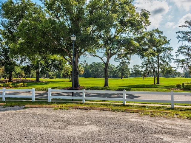 view of community with fence and a yard