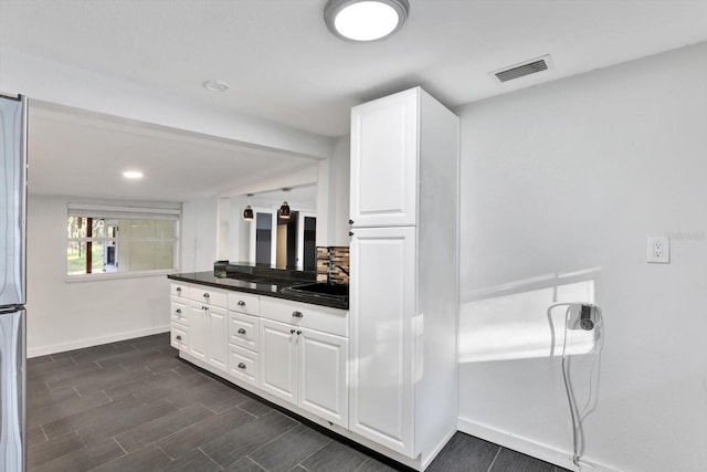 bathroom with vanity and tasteful backsplash