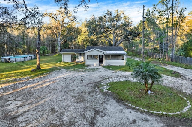 single story home featuring a front yard and a fenced in pool