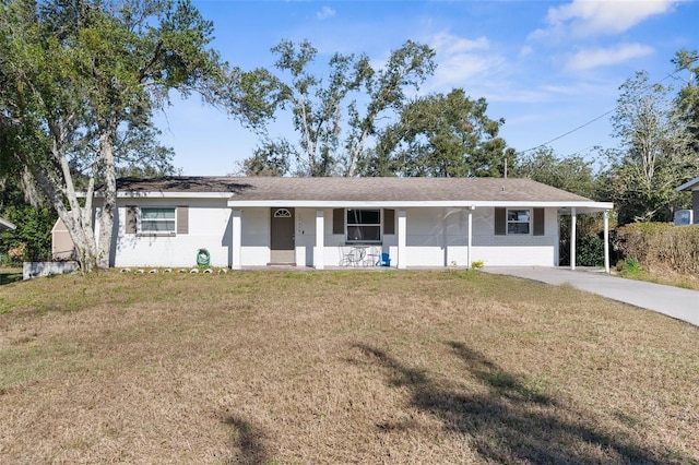 ranch-style home featuring a carport, covered porch, and a front yard