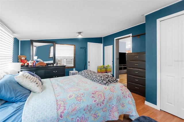 bedroom with lofted ceiling and light wood-type flooring