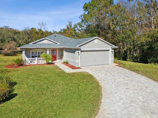 ranch-style home with covered porch, a front yard, and a garage