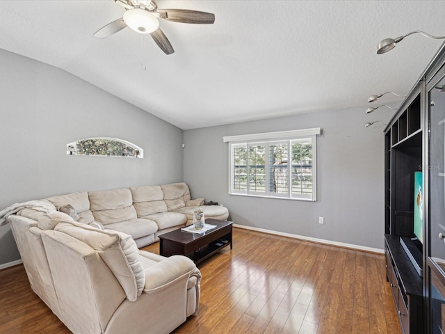 living room featuring hardwood / wood-style flooring, a wealth of natural light, lofted ceiling, and ceiling fan