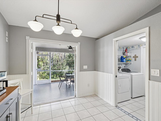 washroom featuring ceiling fan, separate washer and dryer, and light tile patterned floors