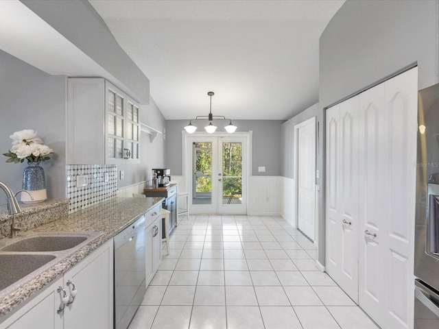 kitchen with dishwasher, french doors, sink, decorative light fixtures, and white cabinetry