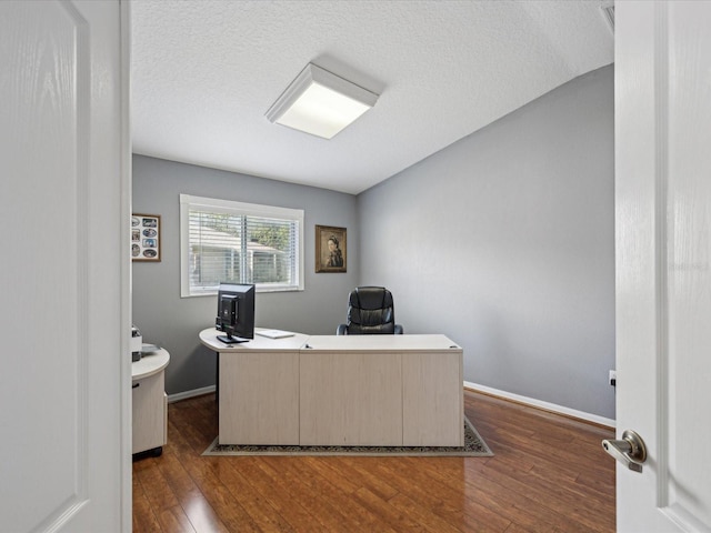 office space featuring a textured ceiling and dark hardwood / wood-style flooring