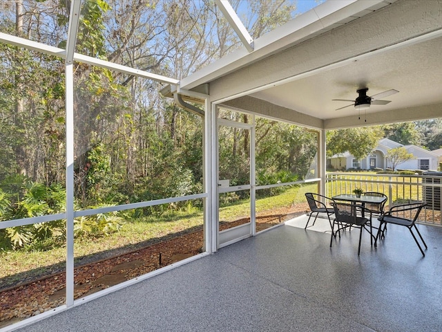 sunroom / solarium with ceiling fan and a healthy amount of sunlight