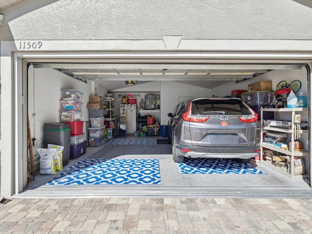 garage with white fridge and a garage door opener