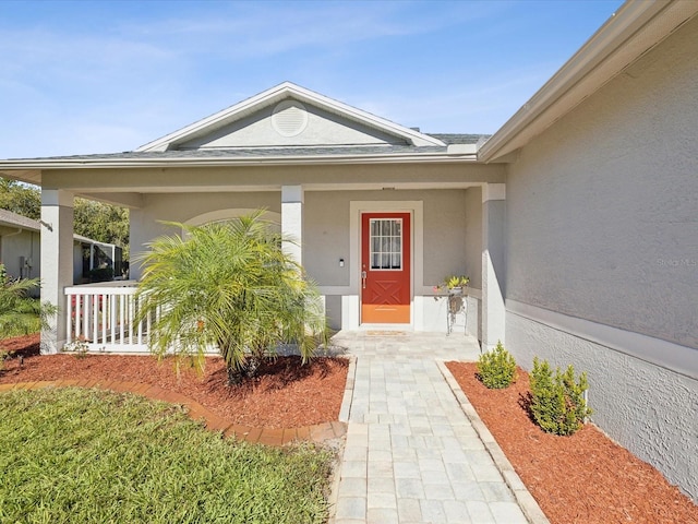 doorway to property with a porch