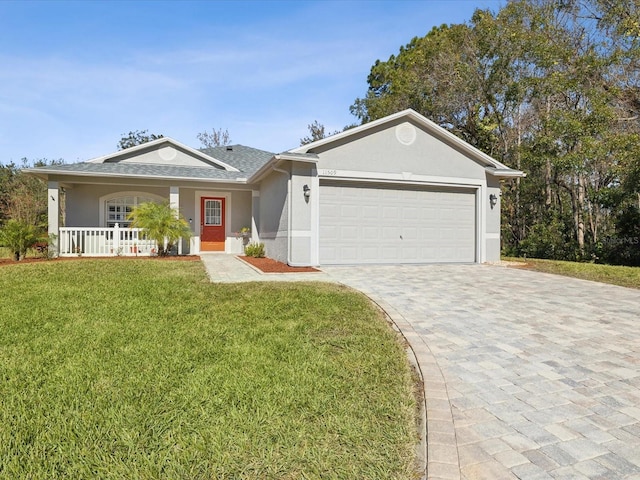 ranch-style home featuring a front yard, a garage, and covered porch