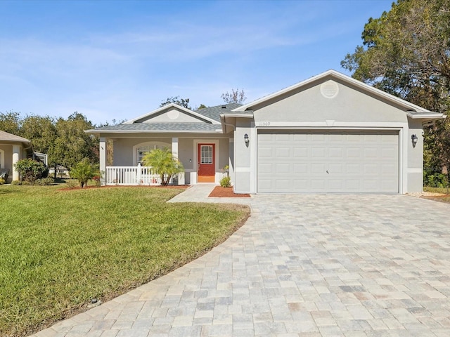 ranch-style home featuring covered porch, a garage, and a front lawn