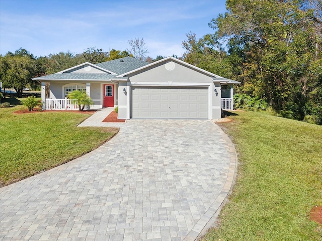 single story home featuring covered porch, a front yard, and a garage