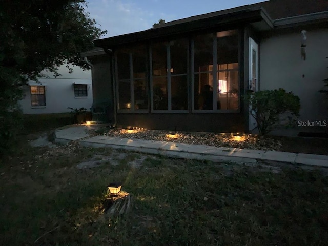 view of property exterior featuring a sunroom