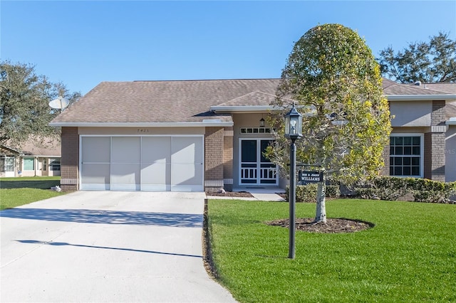 view of front of house with french doors, a front lawn, and a garage