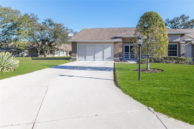 view of front of property with a garage, a front yard, and french doors