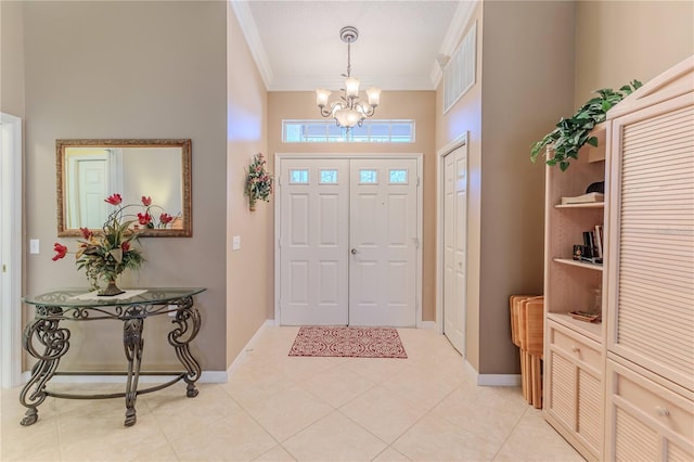 entrance foyer with crown molding, light tile patterned floors, a chandelier, and a high ceiling