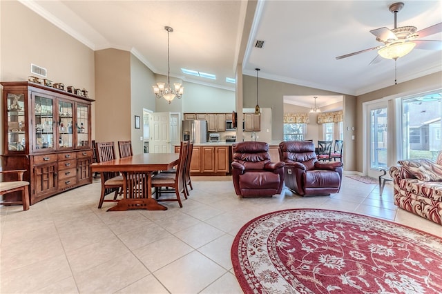 tiled dining space featuring ceiling fan with notable chandelier, ornamental molding, and high vaulted ceiling