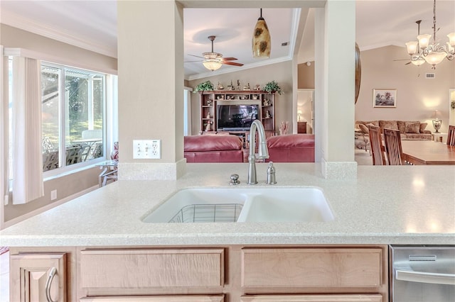 kitchen with crown molding, sink, light brown cabinets, hanging light fixtures, and lofted ceiling