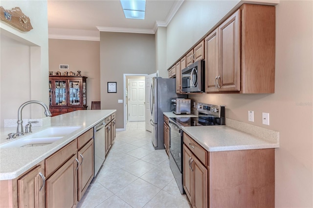 kitchen featuring light tile patterned floors, ornamental molding, sink, and appliances with stainless steel finishes